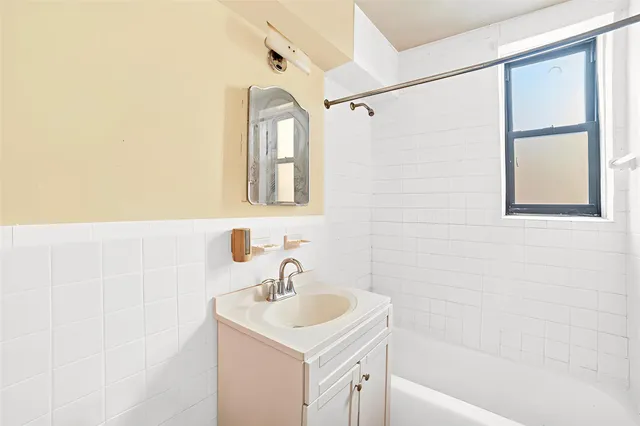 a bathroom with a sink mirror toilet and bathtub