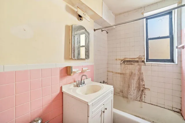 a bedroom with a bed and a potted plant