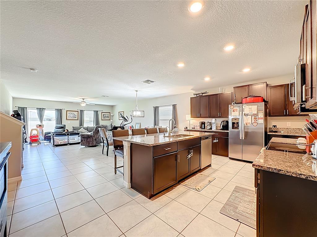1511 Tiger Tooth Place Ruskin, FL 33570 - Photo 18 of 59 a large kitchen with stainless steel appliances lots of counter top space