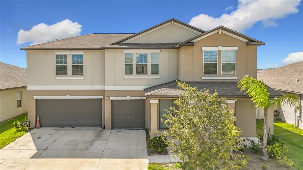 1511 Tiger Tooth Place Ruskin, FL 33570 - Photo 2 of 59 a front view of a house with a yard