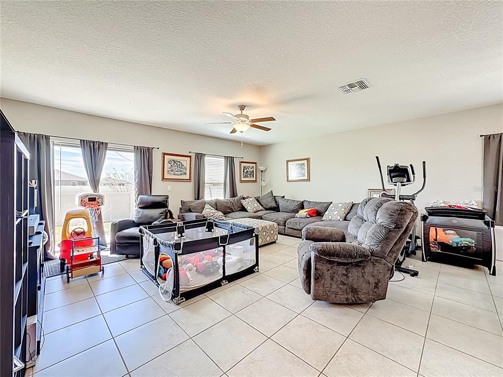 1511 Tiger Tooth Place Ruskin, FL 33570 - Photo 28 of 59 a living room with furniture gym equipment and a window