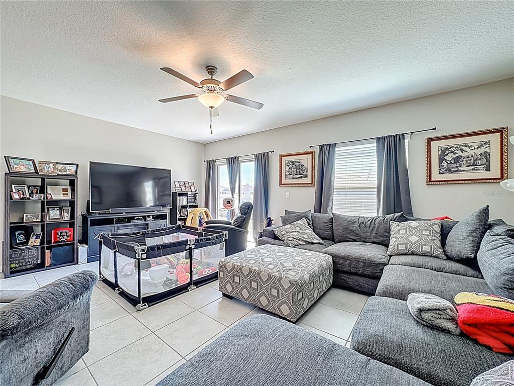 1511 Tiger Tooth Place Ruskin, FL 33570 - Photo 29 of 59 a living room with furniture and a flat screen tv