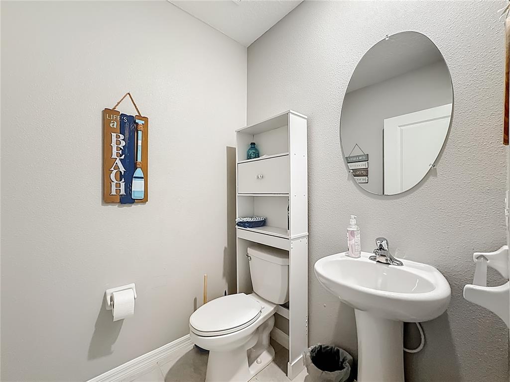 1511 Tiger Tooth Place Ruskin, FL 33570 - Photo 30 of 59 a bathroom with a sink toilet and a mirror