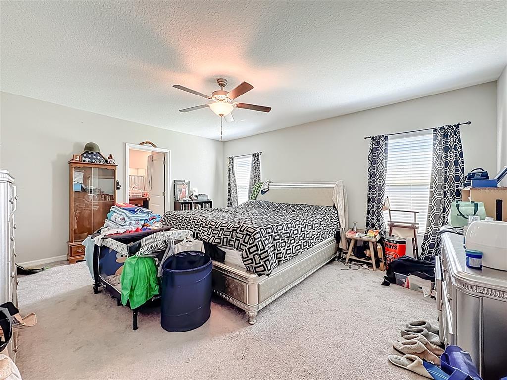 1511 Tiger Tooth Place Ruskin, FL 33570 - Photo 33 of 59 a bed room with a bed and a chair