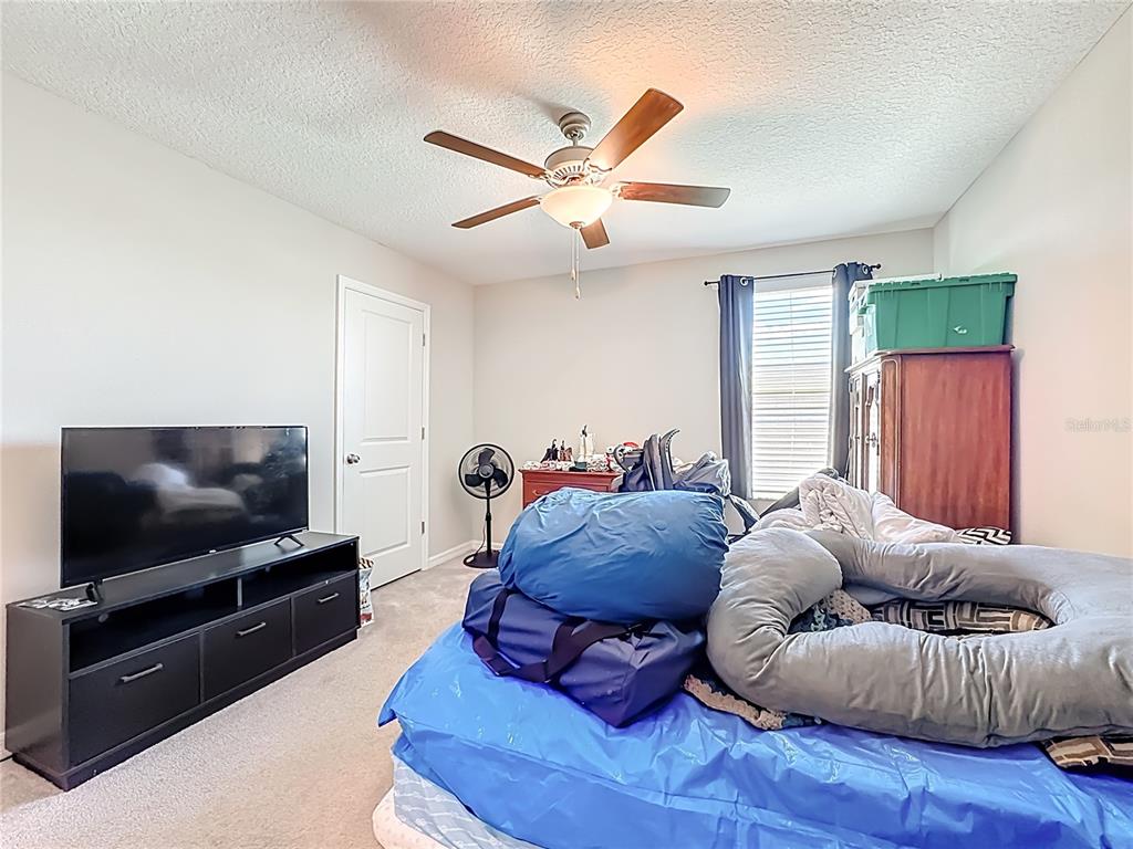 1511 Tiger Tooth Place Ruskin, FL 33570 - Photo 43 of 59 a living room with furniture and a flat screen tv