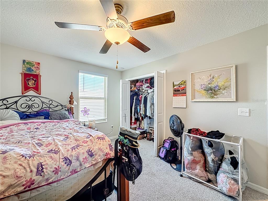 1511 Tiger Tooth Place Ruskin, FL 33570 - Photo 45 of 59 a bedroom with a bed and a walk in closet