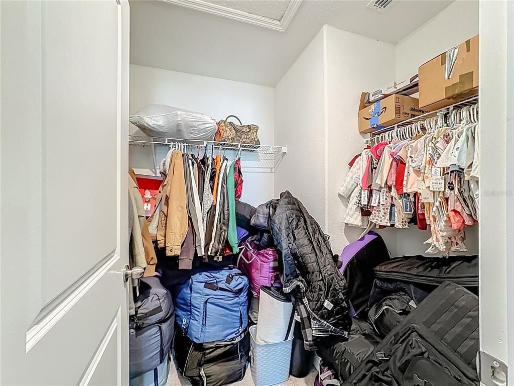 1511 Tiger Tooth Place Ruskin, FL 33570 - Photo 47 of 59 a view of walk in closet with clothes