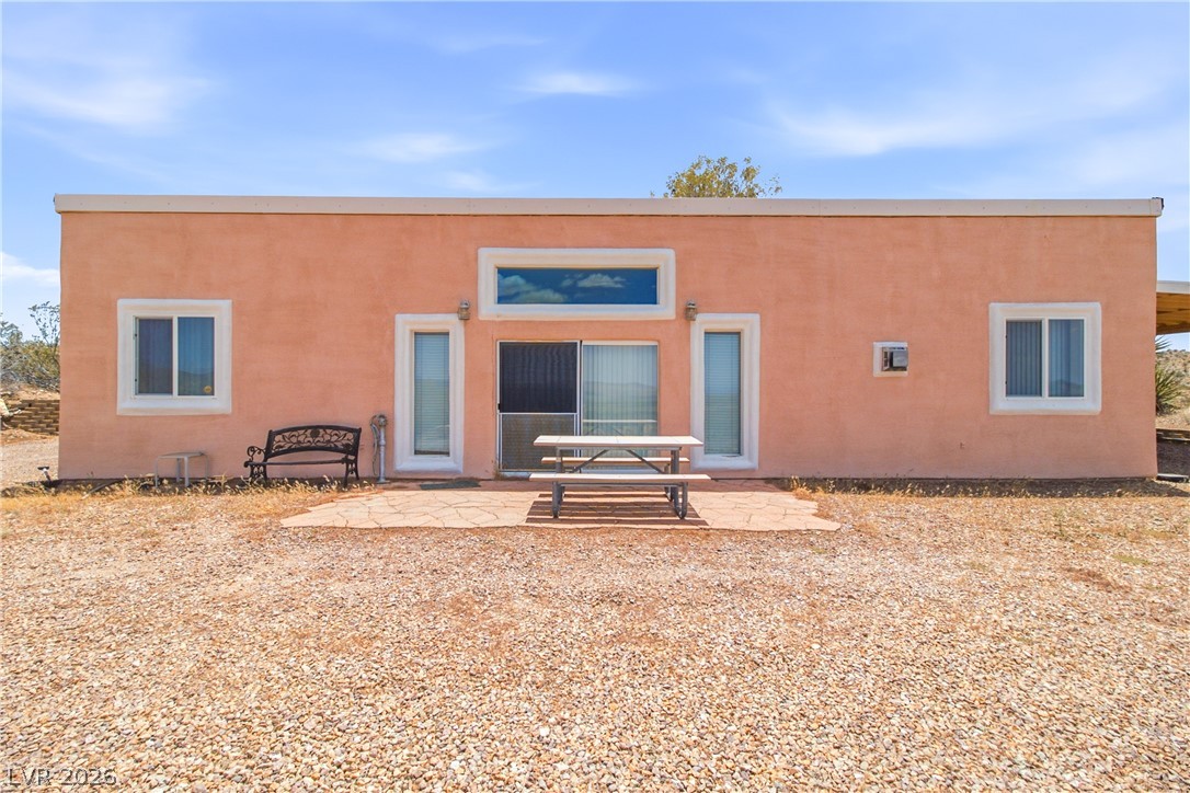 Rocking S Ranch Road Searchlight, NV 89046 - Photo 11 of 47 A terracotta-hued exterior offers a quiet desert escape, complete with a stone patio for outdoor enjoyment.