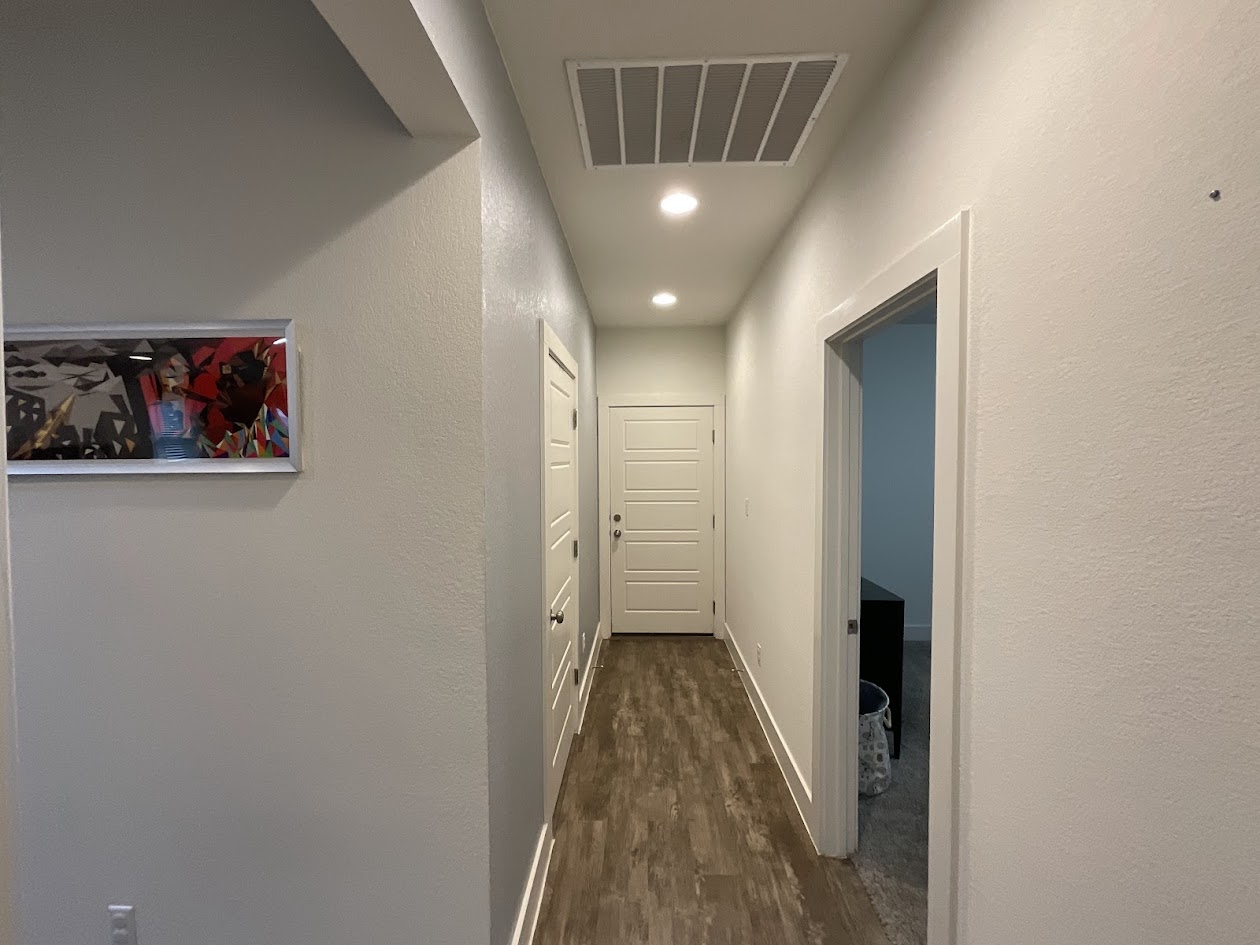 624 Golden Glory Road Leander, TX 78641 - Photo 24 of 39 Hallway featuring wood-finish flooring, recessed lighting, white trim, and white paneled doors