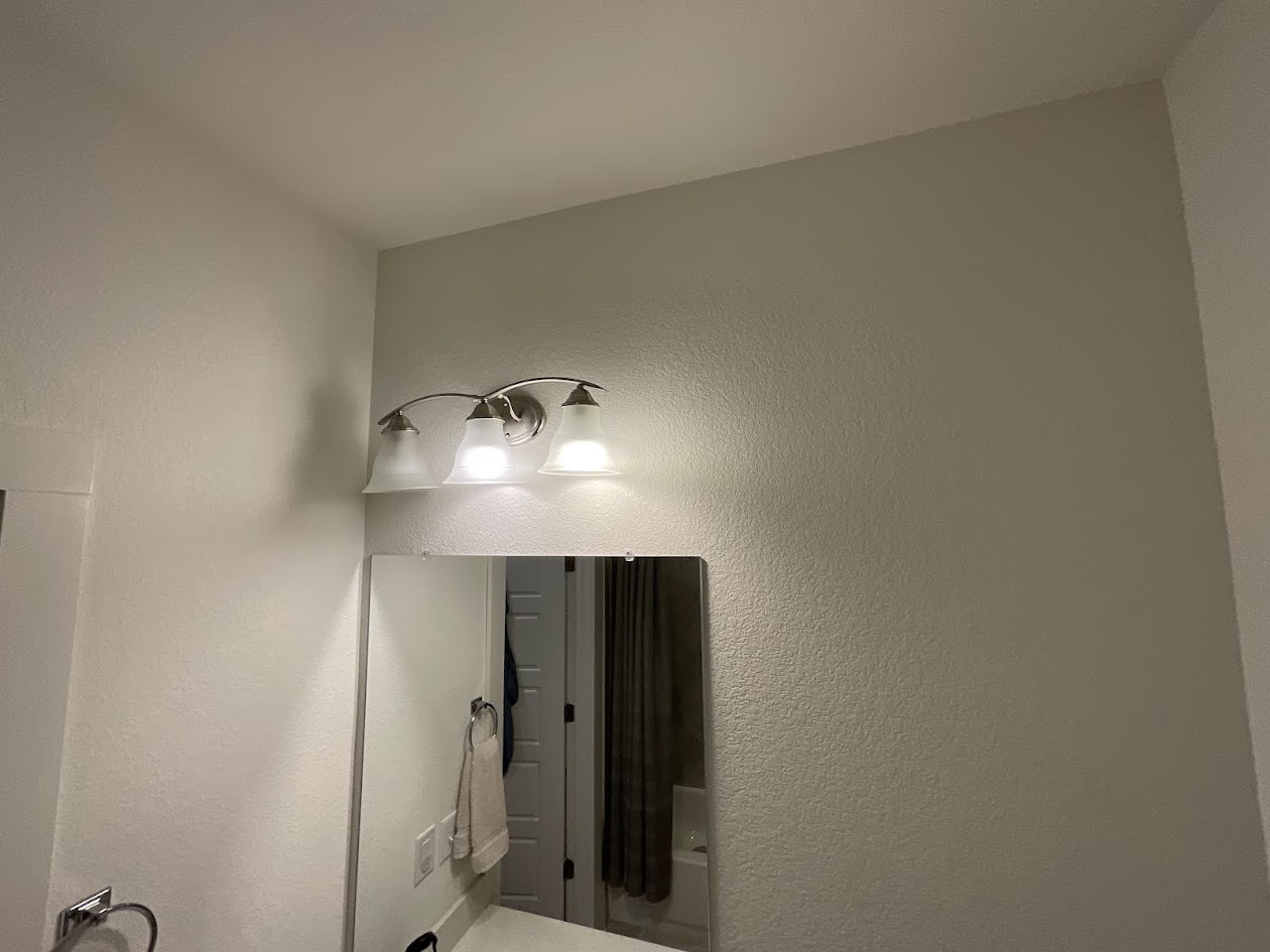 624 Golden Glory Road Leander, TX 78641 - Photo 27 of 39 Brushed nickel vanity light fixture featuring three frosted glass shades
