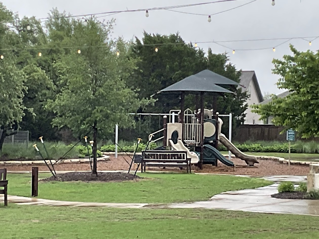 624 Golden Glory Road Leander, TX 78641 - Photo 38 of 39 Community playground featuring a multi-level structure with slides, swings, and a shaded canopy
