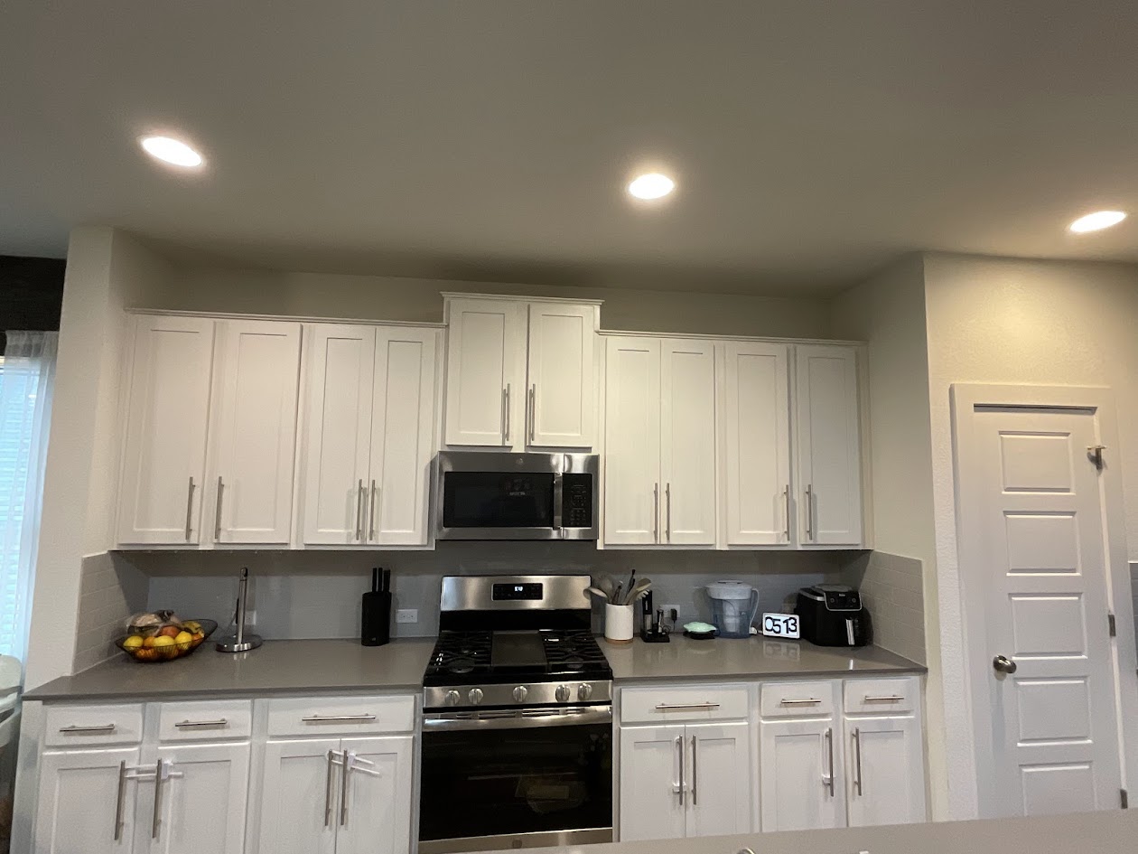 624 Golden Glory Road Leander, TX 78641 - Photo 7 of 39 Kitchen featuring white shaker-style cabinetry, stainless steel appliances, recessed lighting, and grey countertops
