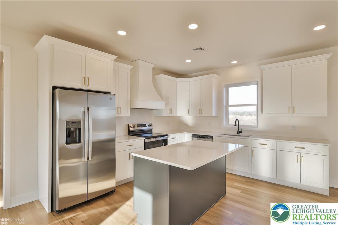 464 Long Lane Road Walnutport, PA 18088 - Photo 13 of 50 a kitchen with a sink a counter top space stainless steel appliances and cabinets