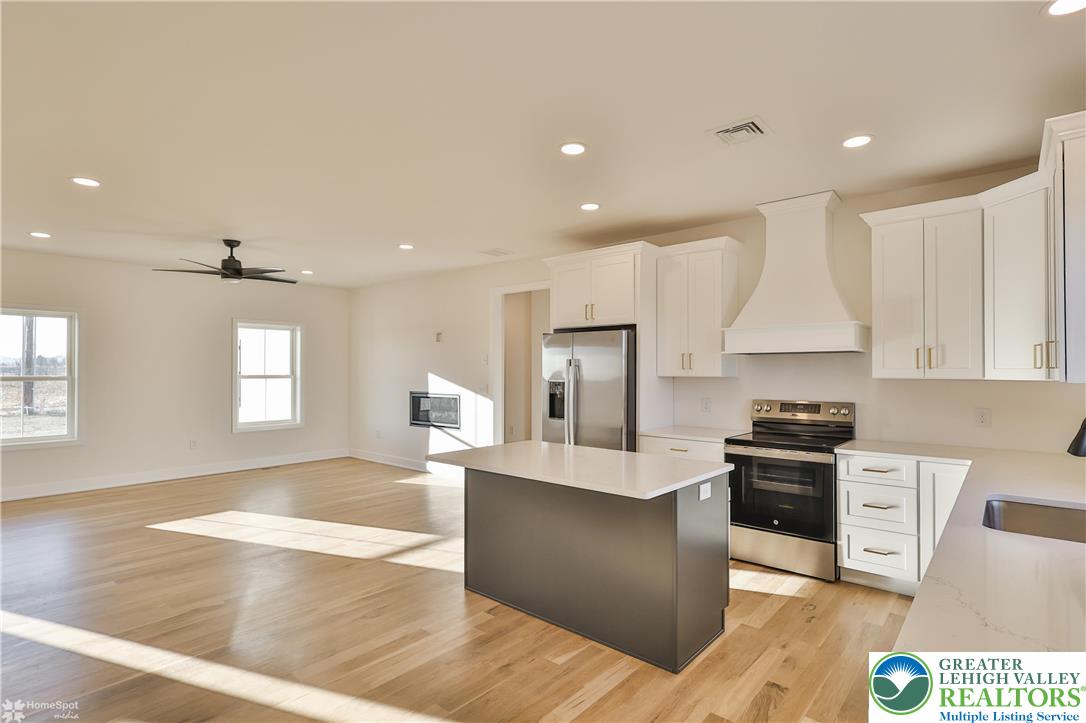 464 Long Lane Road Walnutport, PA 18088 - Photo 15 of 50 a large kitchen with stainless steel appliances kitchen island granite countertop a refrigerator a stove a sink and a counter space