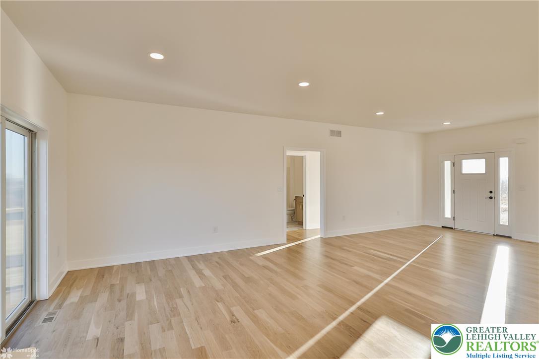 464 Long Lane Road Walnutport, PA 18088 - Photo 20 of 50 an empty room with wooden floor and windows