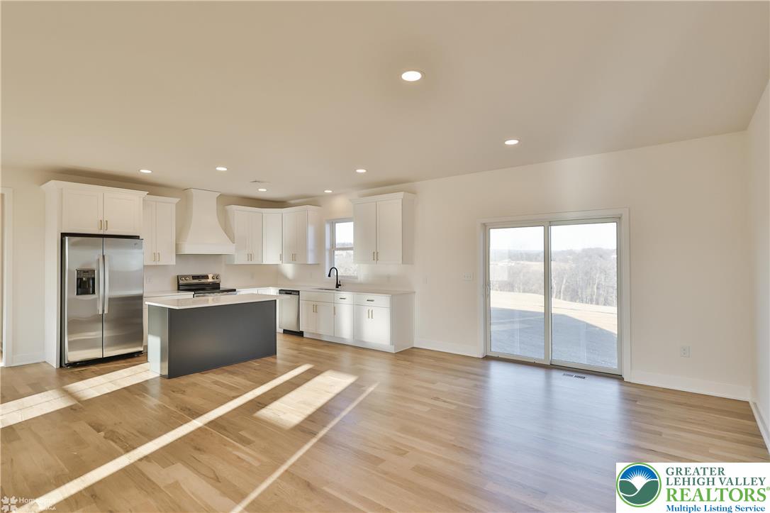 464 Long Lane Road Walnutport, PA 18088 - Photo 22 of 50 a large kitchen with stainless steel appliances kitchen island a large counter top and a wooden floors