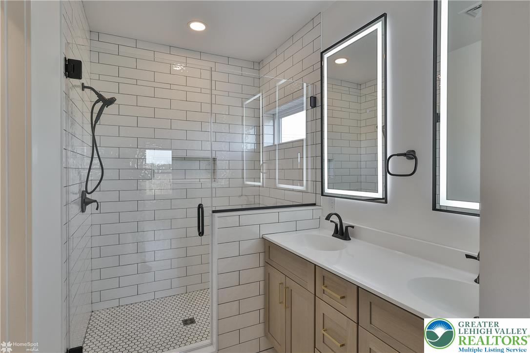 464 Long Lane Road Walnutport, PA 18088 - Photo 43 of 50 a bathroom with a shower sink and mirror