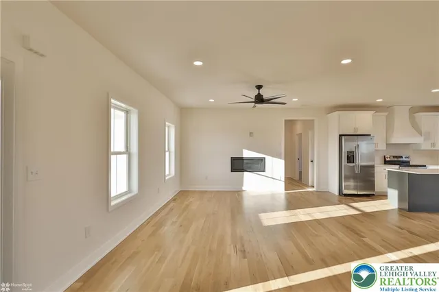 a view of a kitchen with a sink and a large window