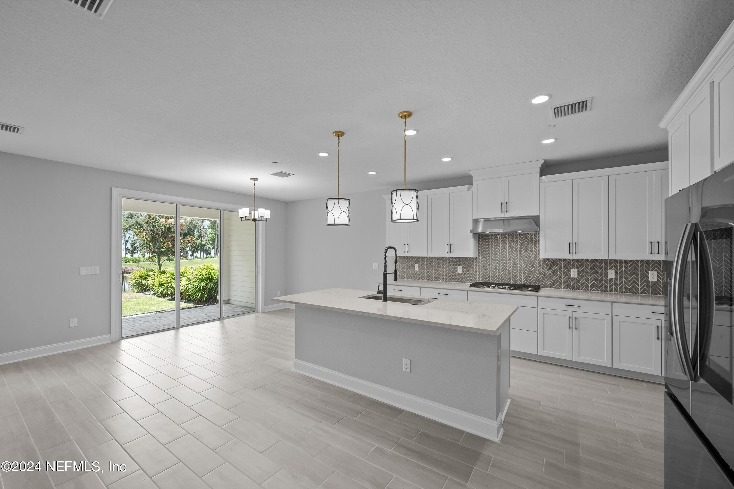27 Oak Pk Drive St. Johns, FL 32259 - Photo 13 of 71 a large kitchen with stainless steel appliances kitchen island a large counter top and a wooden floors