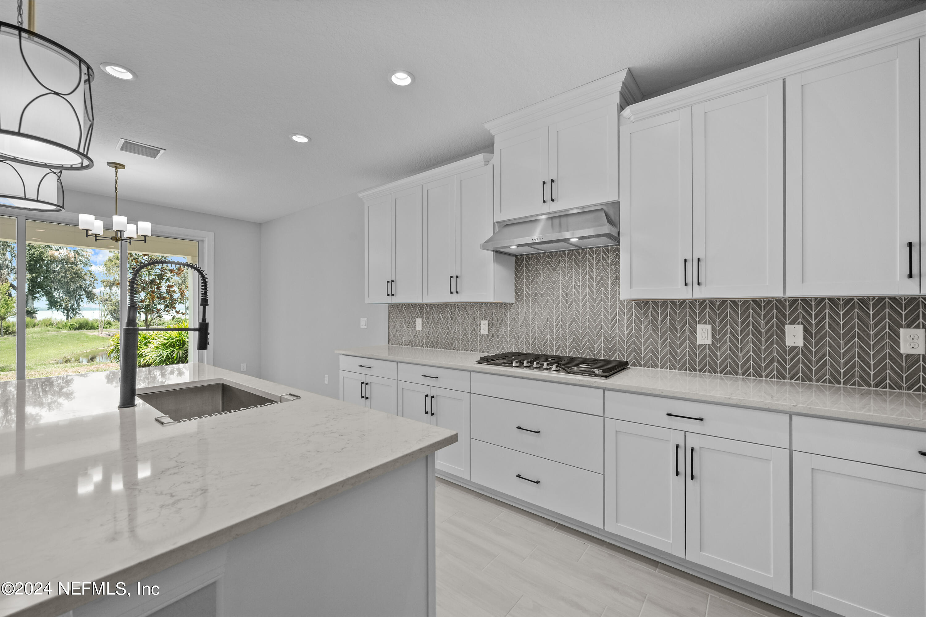 27 Oak Pk Drive St. Johns, FL 32259 - Photo 15 of 71 a kitchen with white cabinets and sink