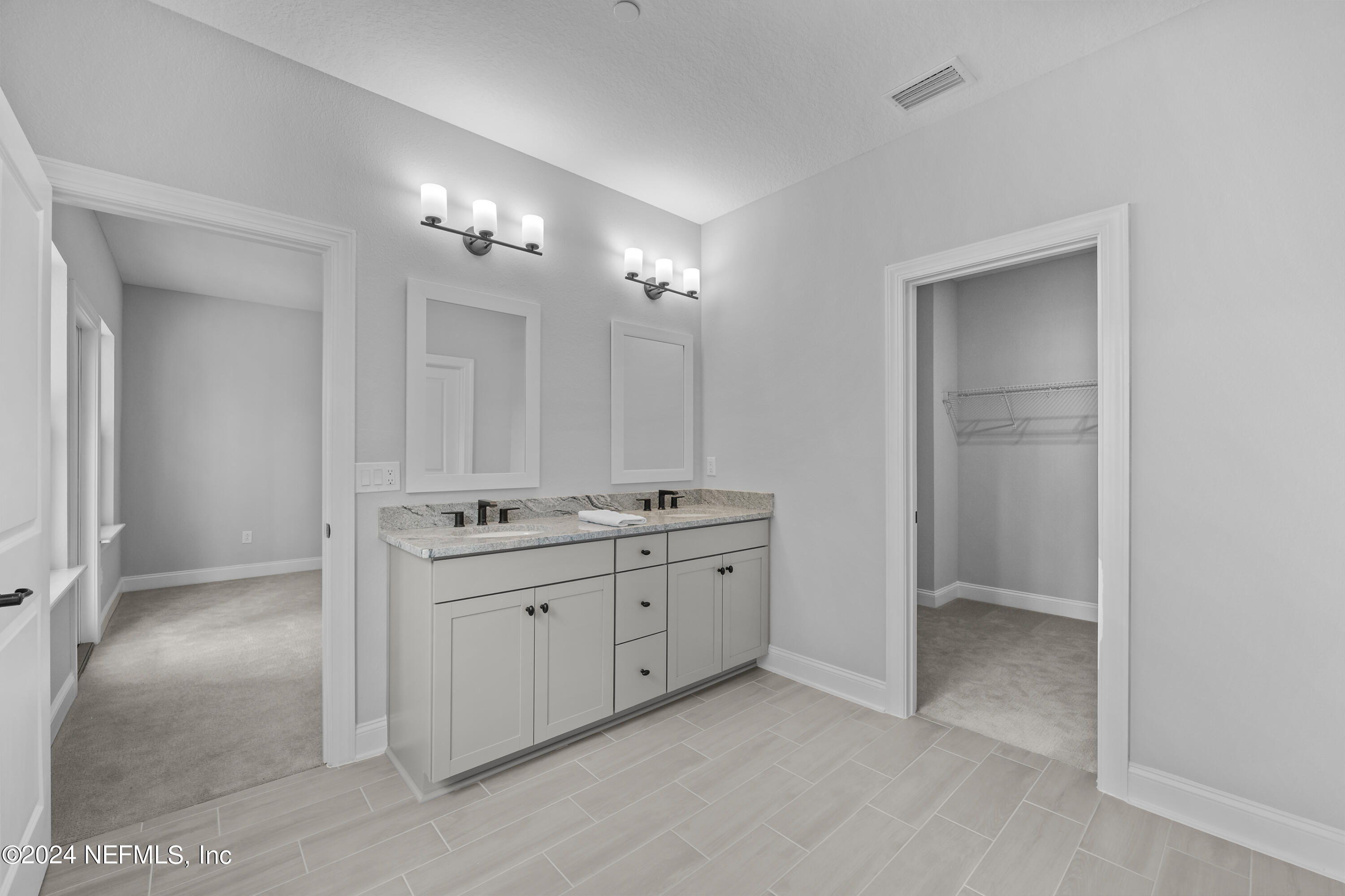 27 Oak Pk Drive St. Johns, FL 32259 - Photo 31 of 71 a bathroom with a double vanity sink and mirror