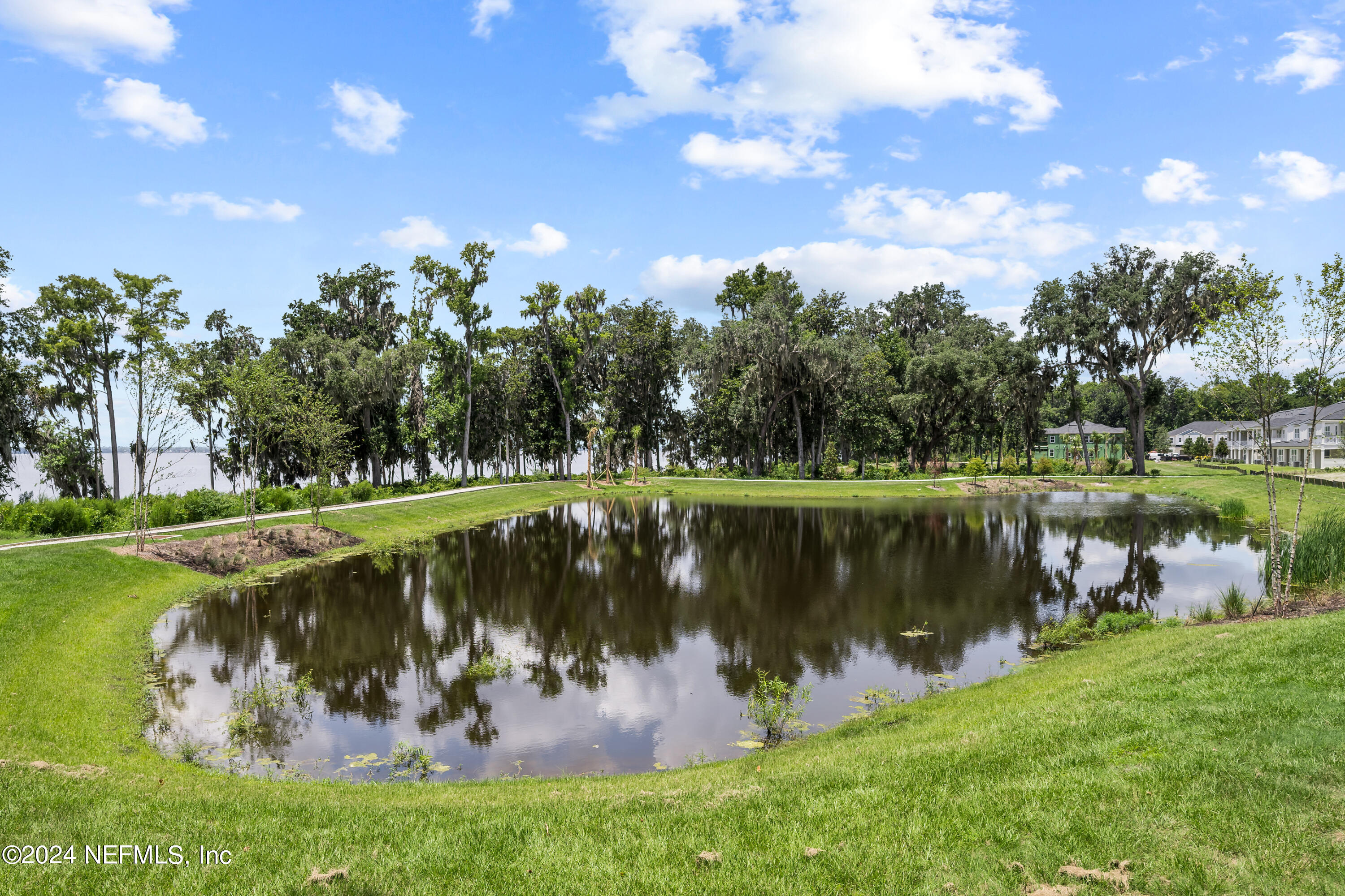 27 Oak Pk Drive St. Johns, FL 32259 - Photo 46 of 71 a view of a lake with a big yard and potted plants