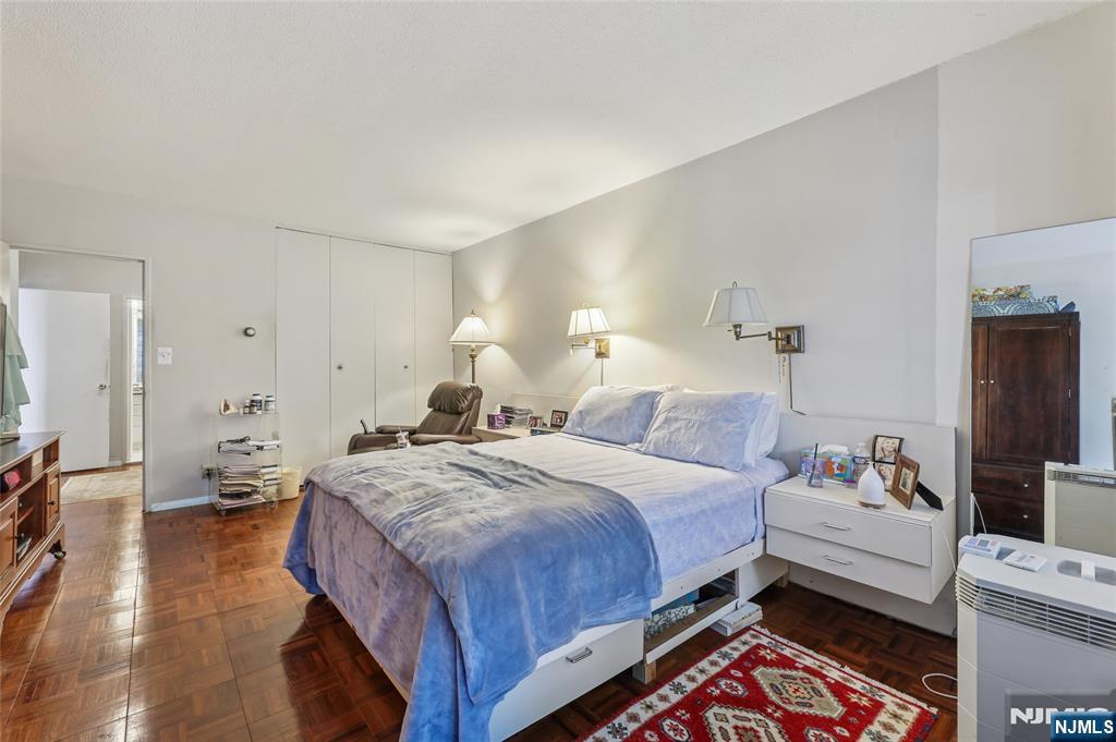 6 Horizon Road, Unit 2106 Fort Lee, NJ 07024 - Photo 13 of 20 a bedroom with a bed and a couch