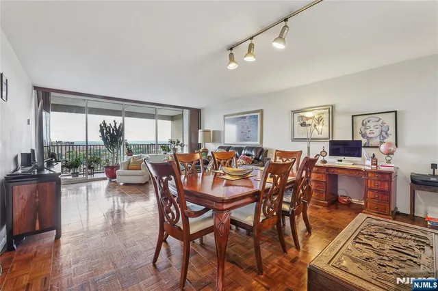 a view of a dining room with furniture large windows and wooden floor