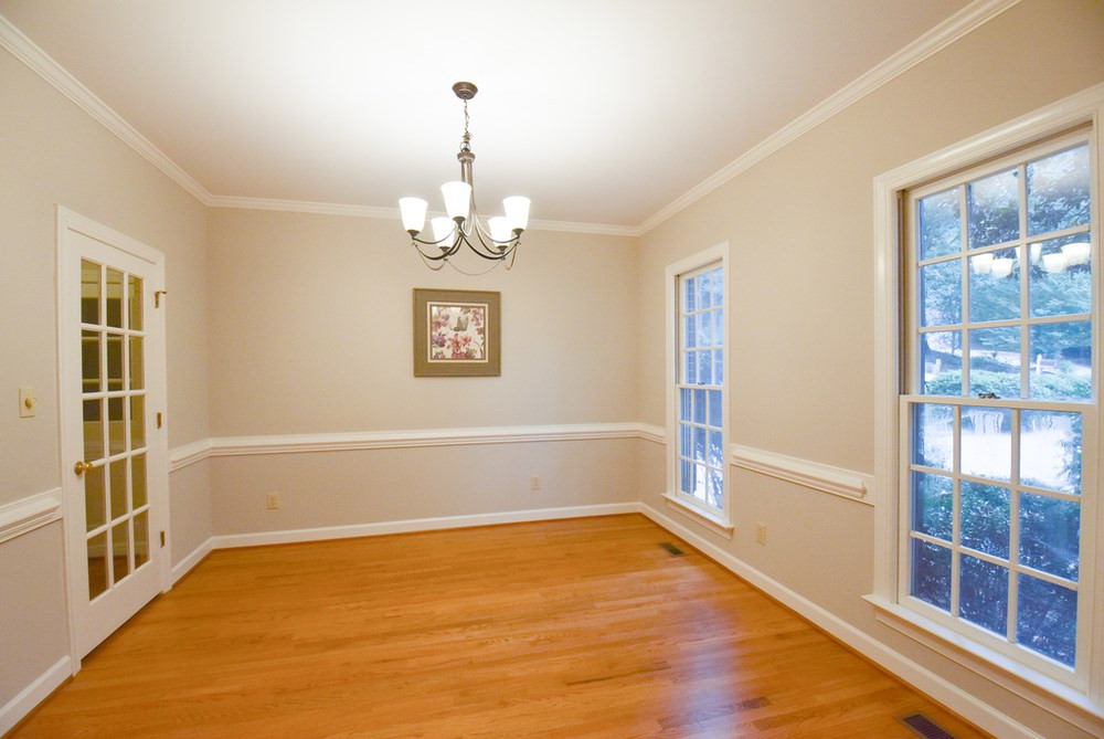 9004 Enfield Court Raleigh, NC 27615 - Photo 4 of 30 Formal Dining Rm w/hardwood flr, crown/chair rail molding, bronze iron light fixture & glass door to Kitchen. Dining Room