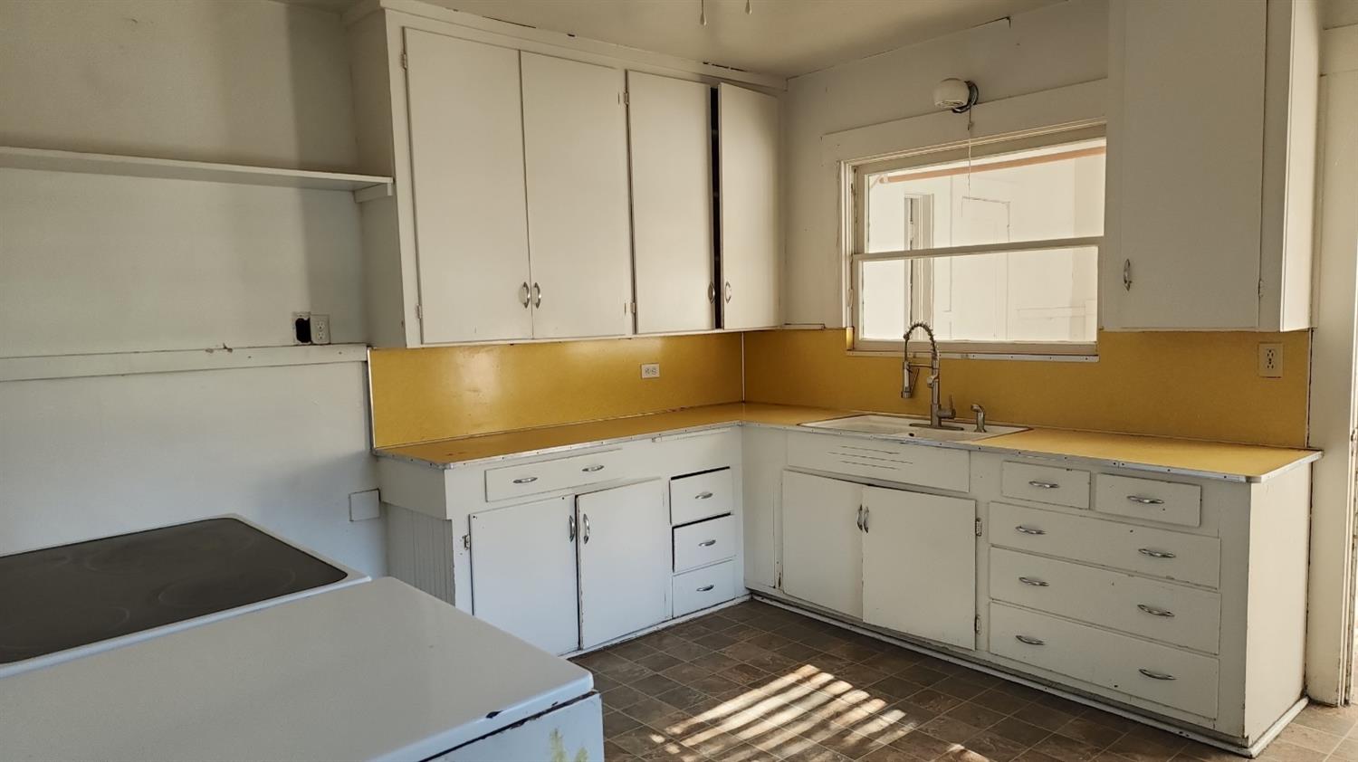 406 2nd Street Arbuckle, CA 95912 - Photo 11 of 31 a kitchen with granite countertop white cabinets and sink