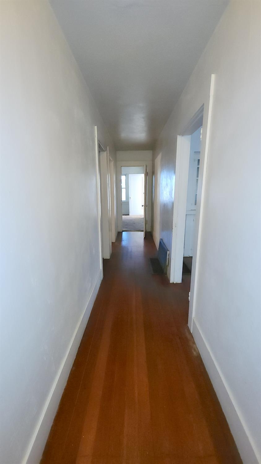 406 2nd Street Arbuckle, CA 95912 - Photo 23 of 31 a view of a hallway with wooden floor