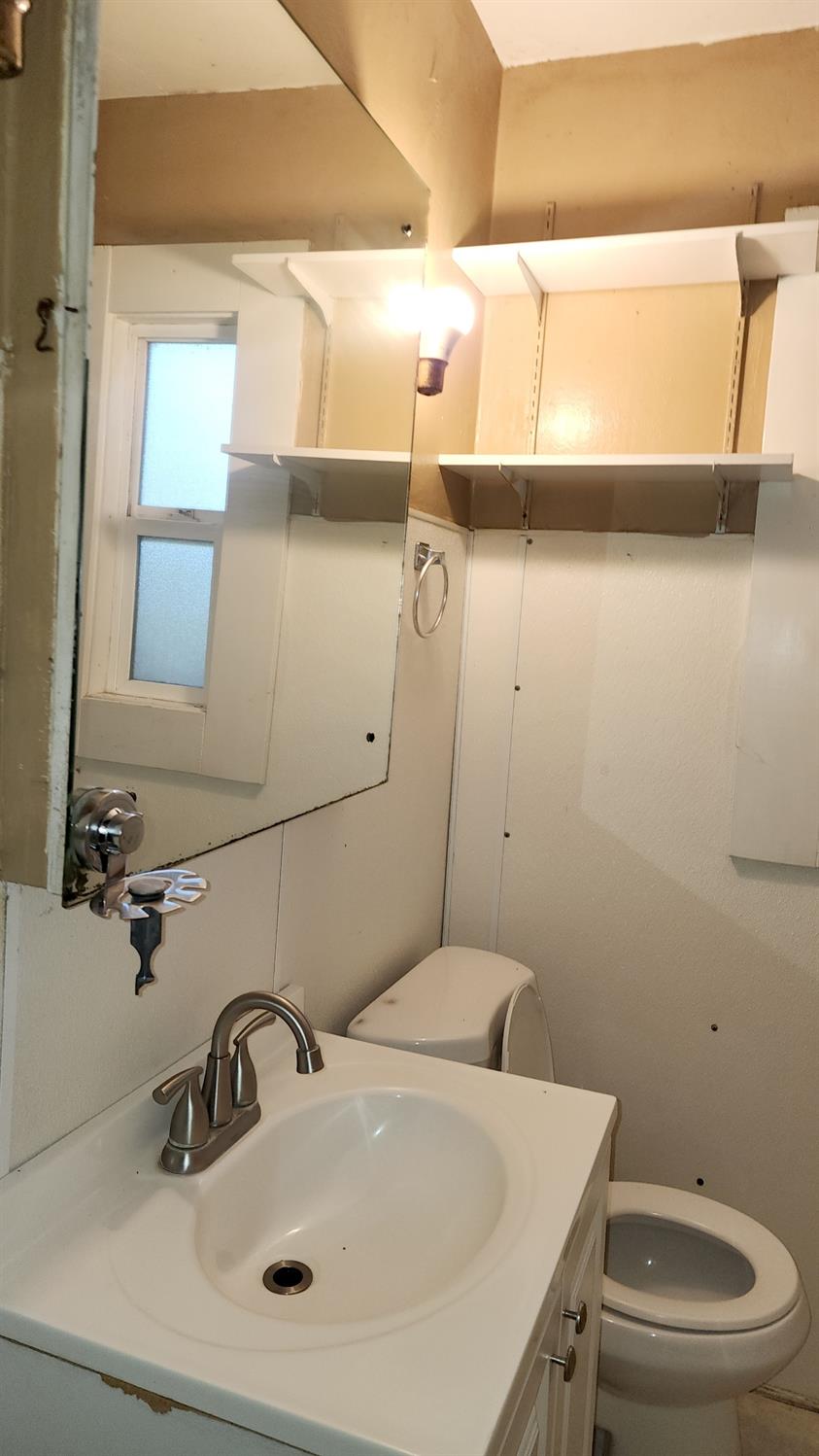 406 2nd Street Arbuckle, CA 95912 - Photo 25 of 31 a bathroom with a sink and a toilet