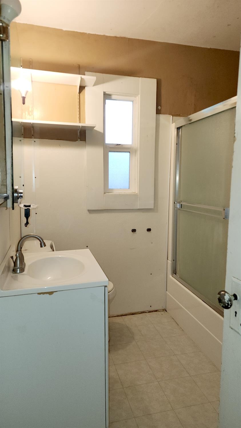 406 2nd Street Arbuckle, CA 95912 - Photo 26 of 31 a bathroom with a sink and a mirror