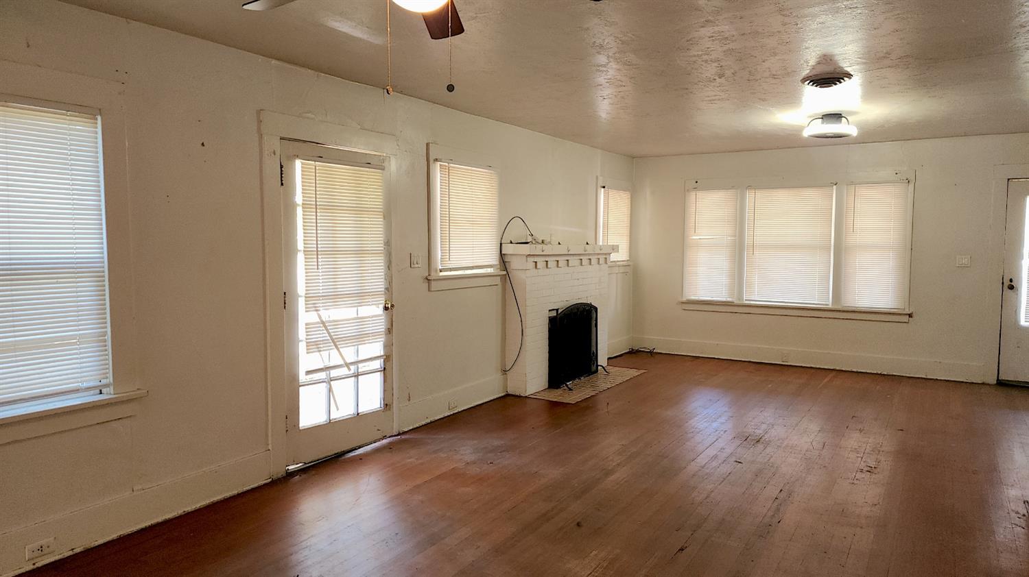 406 2nd Street Arbuckle, CA 95912 - Photo 10 of 31 a view of an empty room with a window and wooden floor