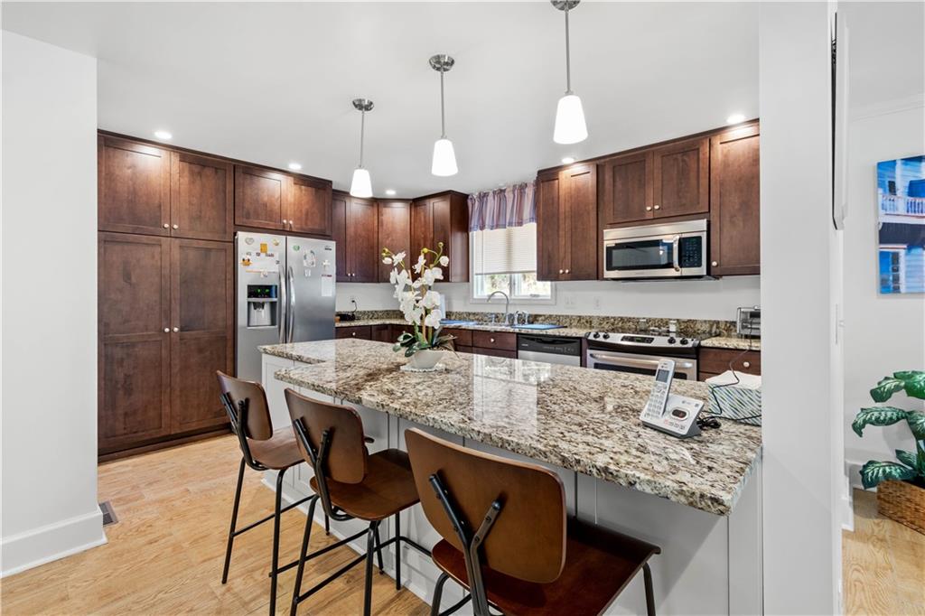 3 Agostoni Road Eighty Four, PA 15330 - Photo 8 of 25 a kitchen with stainless steel appliances granite countertop a sink a stove a refrigerator cabinets and chairs