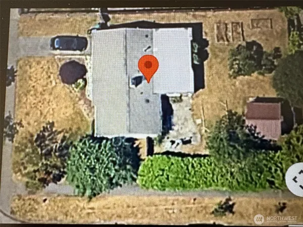 an aerial view of a house with a yard and many windows