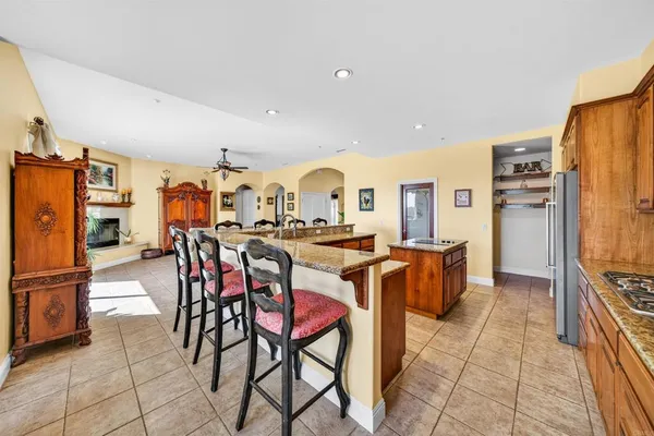 a kitchen with stainless steel appliances granite countertop a stove a sink and a wooden cabinets