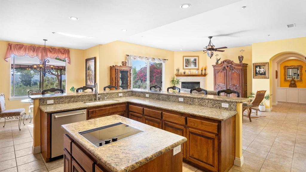 40487 Rock Mountain Drive Fallbrook, CA 92028 - Photo 12 of 57 a kitchen with a sink a counter and chairs
