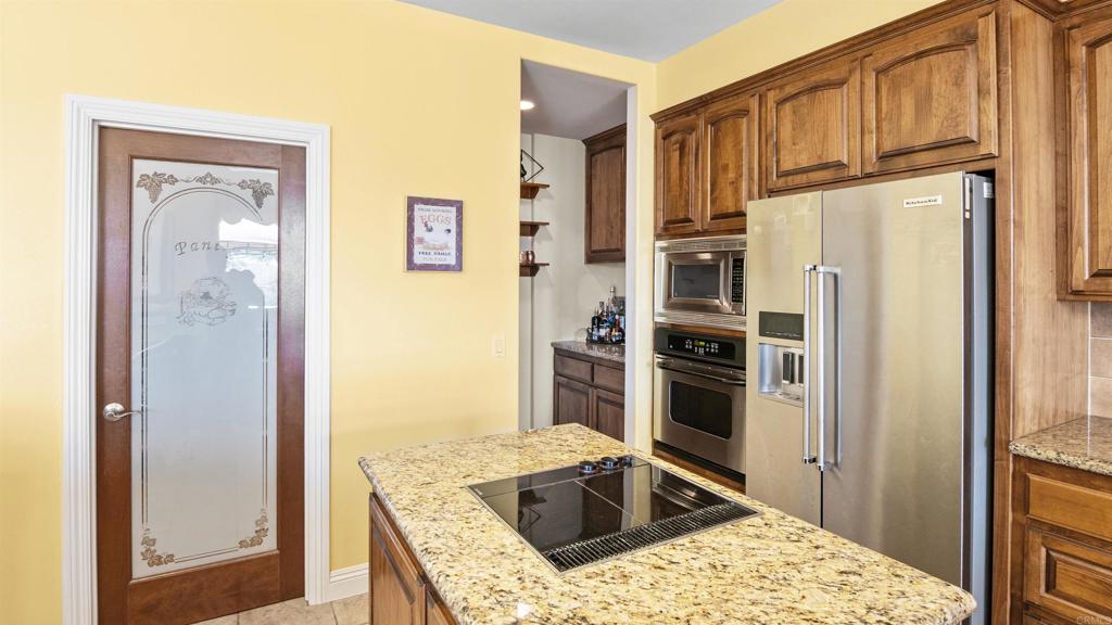 40487 Rock Mountain Drive Fallbrook, CA 92028 - Photo 18 of 57 a kitchen with stainless steel appliances granite countertop a refrigerator and a sink