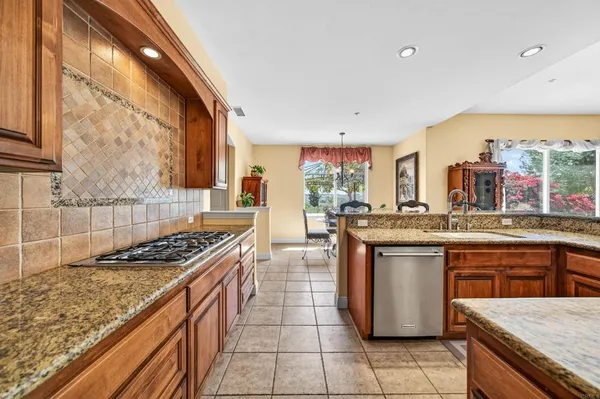 a large bathroom with a granite countertop double vanity sink a bathtub and shower