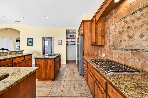 a spacious bathroom with a tub sink and mirror