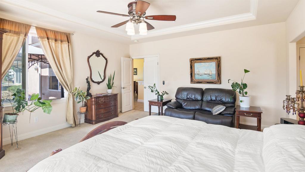 40487 Rock Mountain Drive Fallbrook, CA 92028 - Photo 23 of 57 a bed room with a bed and a chandelier