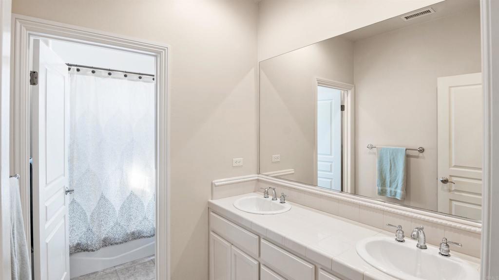 40487 Rock Mountain Drive Fallbrook, CA 92028 - Photo 27 of 57 a bathroom with a sink and a mirror