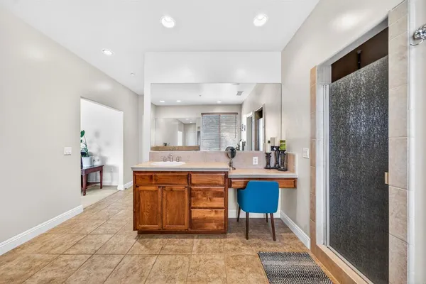 an empty room with windows and ceiling fan
