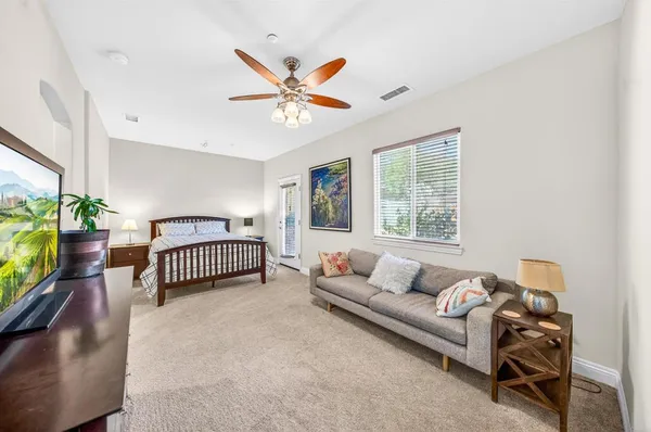 a living room with furniture pool table and a flat screen tv