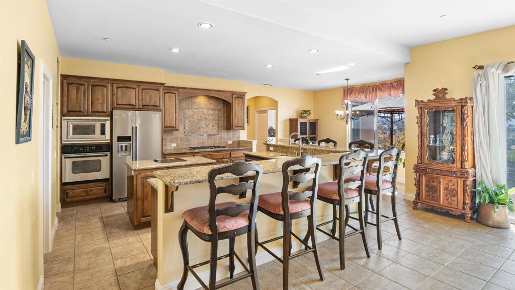 40487 Rock Mountain Drive Fallbrook, CA 92028 - Photo 4 of 57 a large kitchen with a table and chairs