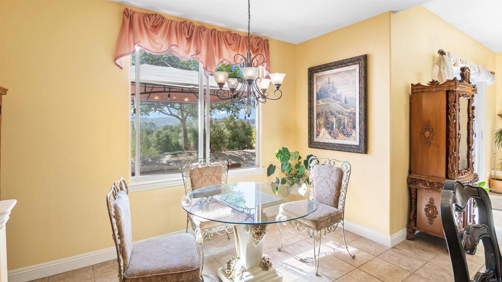 40487 Rock Mountain Drive Fallbrook, CA 92028 - Photo 6 of 57 a dining room with furniture a chandelier and window