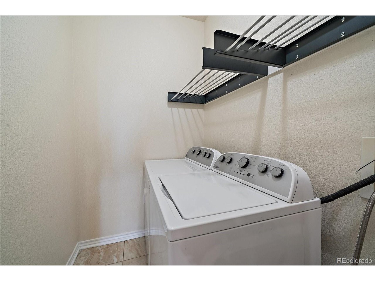 18611 Stroh Road, Unit 102 Parker, CO 80134 - Photo 17 of 19 full size laundry room with hanging rack
