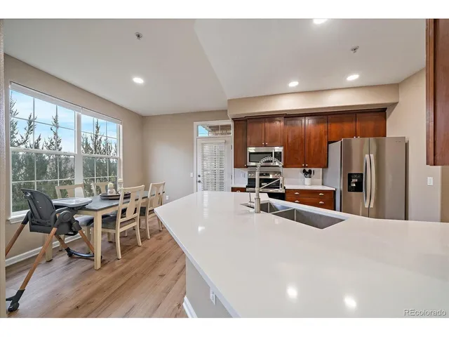 a kitchen with stainless steel appliances a stove refrigerator sink and microwave