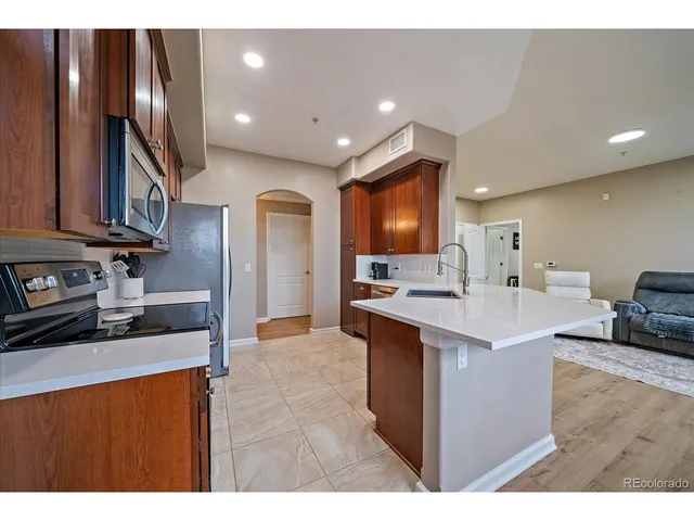 a large kitchen with stainless steel appliances lots of counter top space